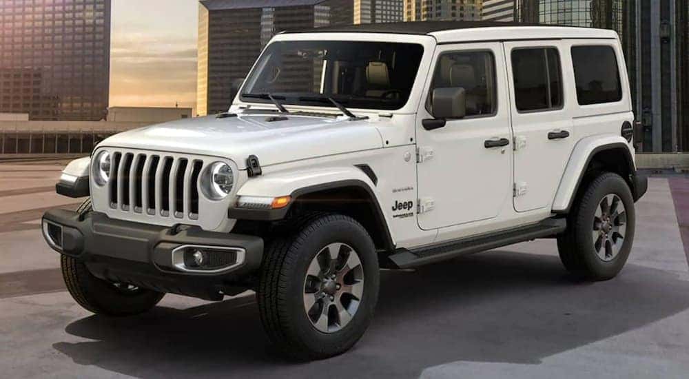 A white 2021 Jeep Wrangler is shown from a side angle after looking at new cars in stock near you.