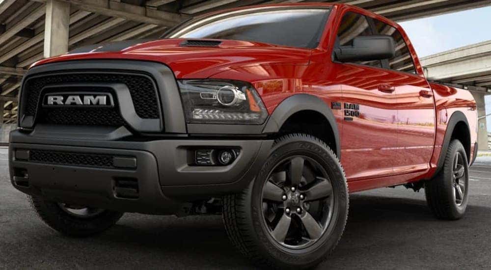 A red 2019 Ram 1500 is shown parked on cement after leaving a used Ram truck dealership in Lexington.