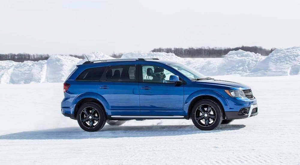 A blue 2020 Dodge Journey is shown from the side and parked in the snow after leaving a Dodge Journey dealer.