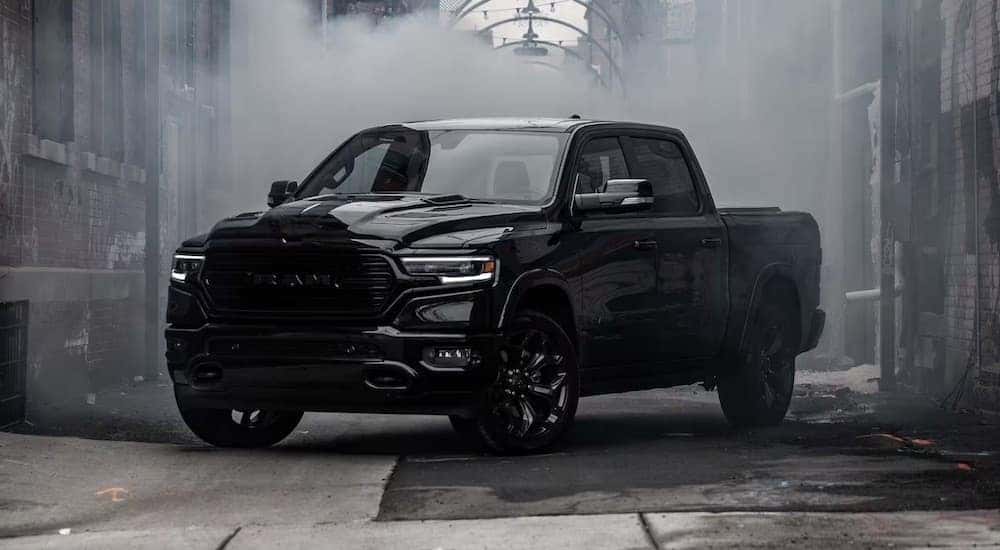 A black 2023 Ram 1500 is shown from the front at an angle.