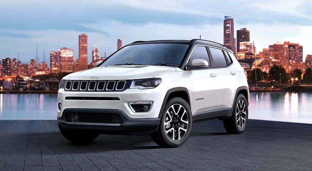 A white 2017 Jeep Compass is parked overlooking a city after leaving the used Jeep dealer in Lexington.