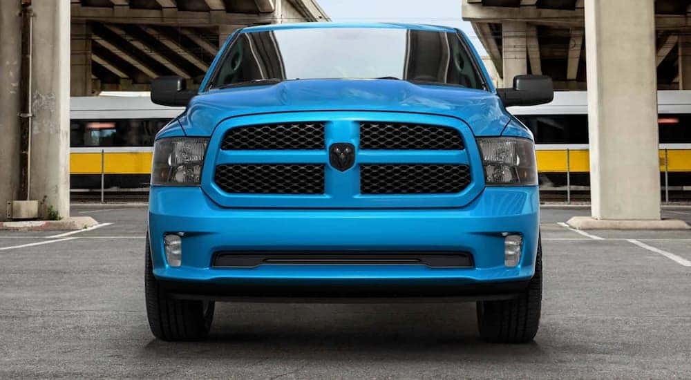A blue 2020 Ram 1500 Classic is shown from the front in a parking garage.