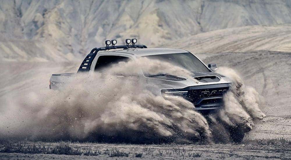The newest Ram truck, a 2021 Ram 1500 TRX, is kicking up sand while off-roading.