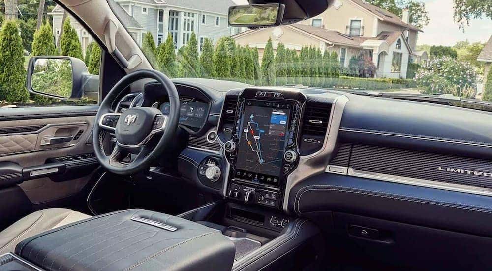 The brown and black interior of a 2024 Ram 1500 Limited is shown from the passenger seat.