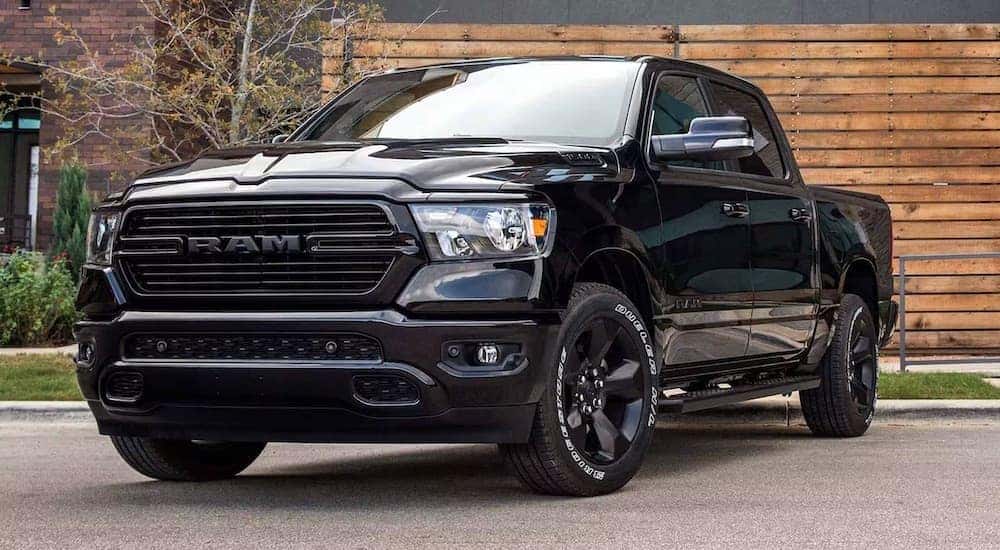 A black 2024 Ram 1500 is shown from the front at an angle.