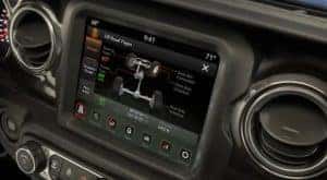 The black interior of a 2022 Jeep Wrangler Rubicon Xtreme Recon shows the infotainment screen.