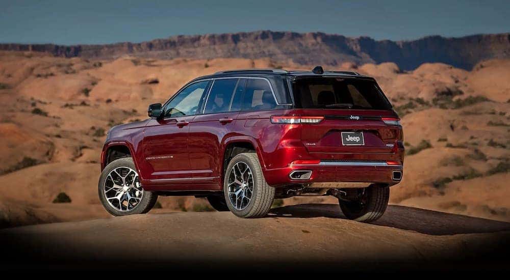 A red 2022 Jeep Grand Cherokee is shown from the rear at an angle.