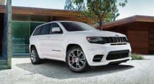 A white 2020 used Jeep Grand Cherokee SRT is shown parked in a driveway.