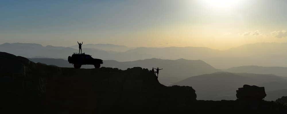 People and Jeep Wrangler on Mountain top