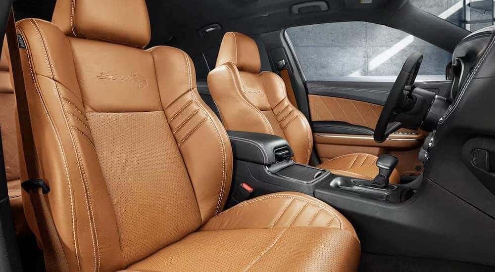 The tan interior of a 2023 Dodge Charger Hellcat is shown from the passenger side.