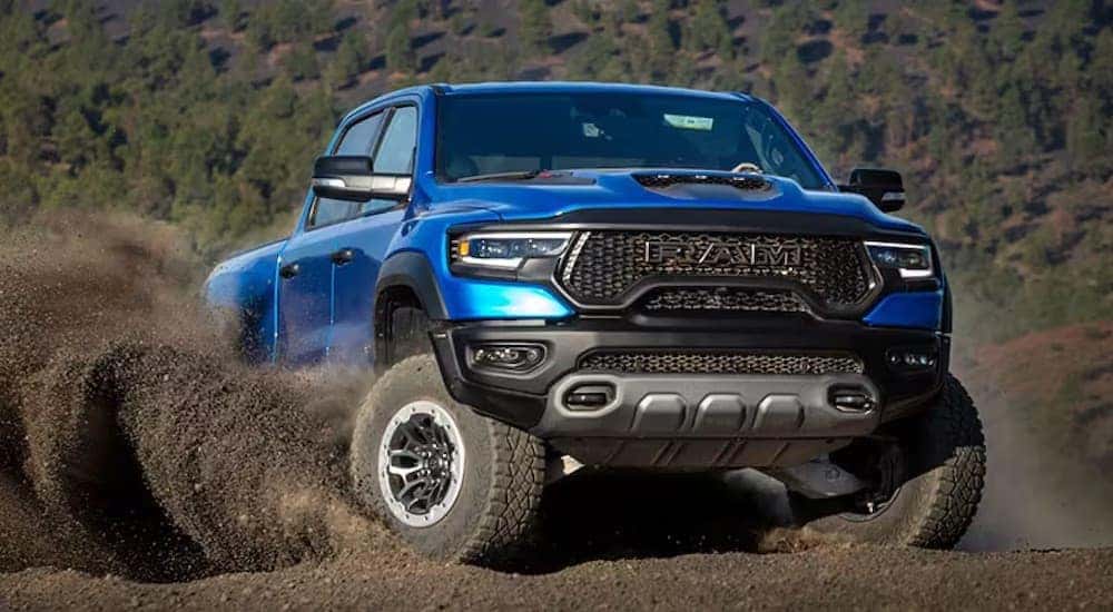 A blue 2023 Ram 1500 TRX is shown from the front while off-road.