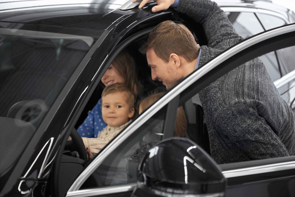 Family looking at an SUV