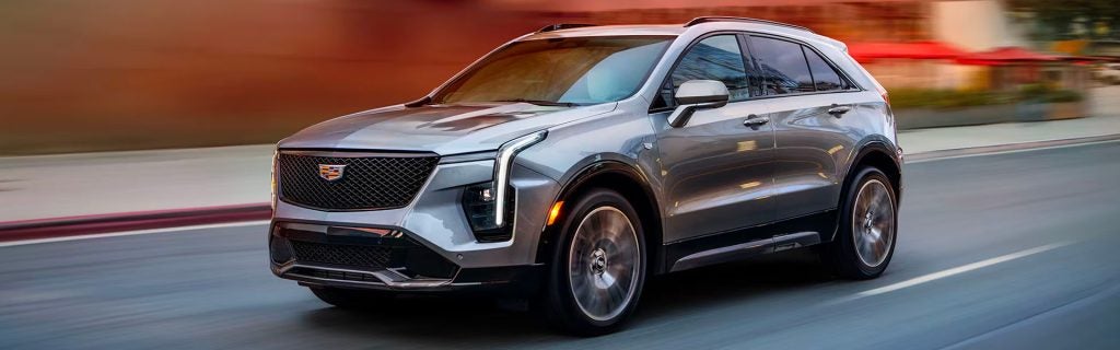 A silver Cadillac XT4 SUV on the road.