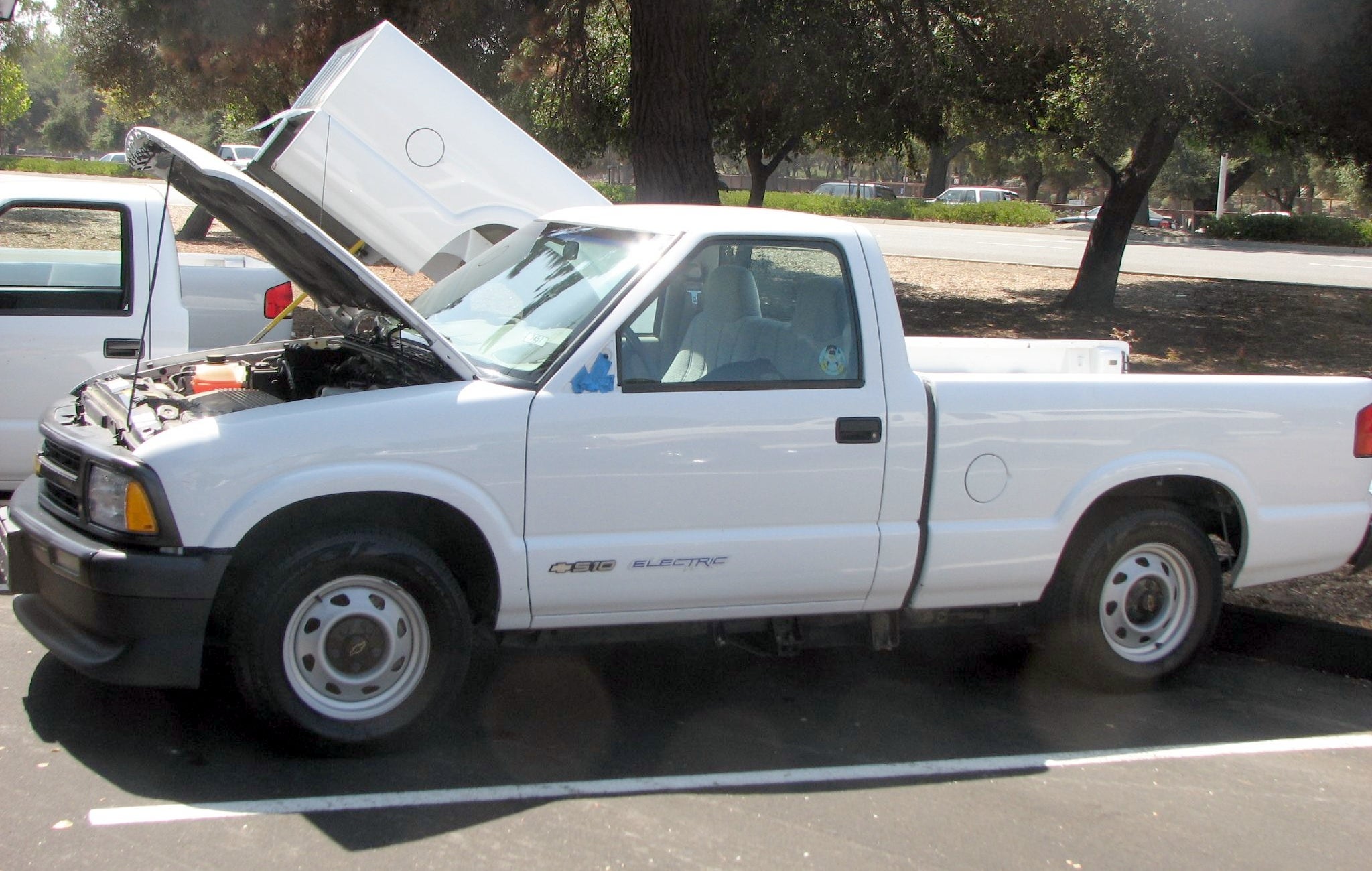 White Chevrolet S-10 EV parked with the hood up