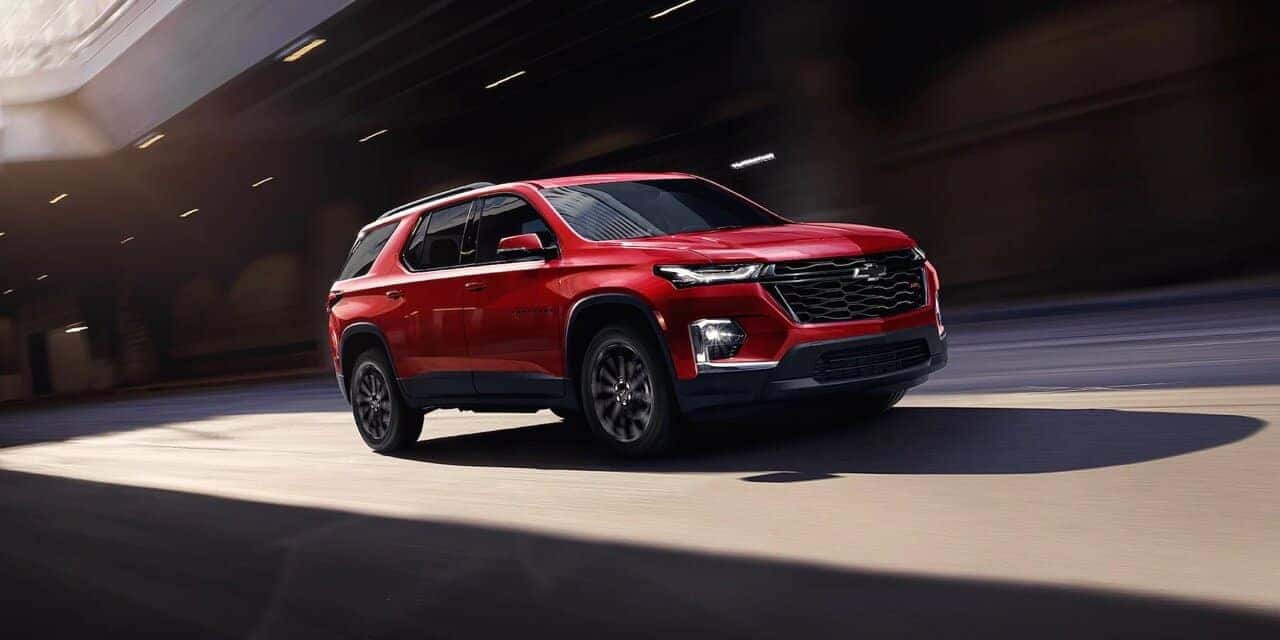 Red 2023 Chevy Traverse Driving on Road