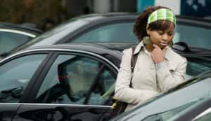A woman looking at cars