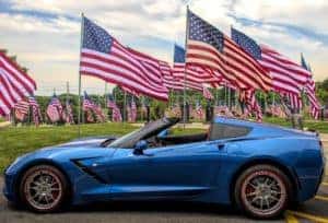 A blue Corvette and lots of flags 