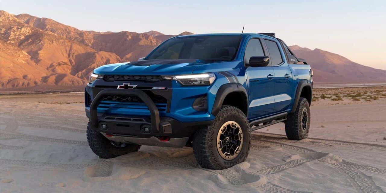 Blue 2023 Chevrolet Colorado parked in sanddunes