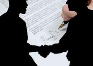 Shadowed image of Two people shsaking hands 
