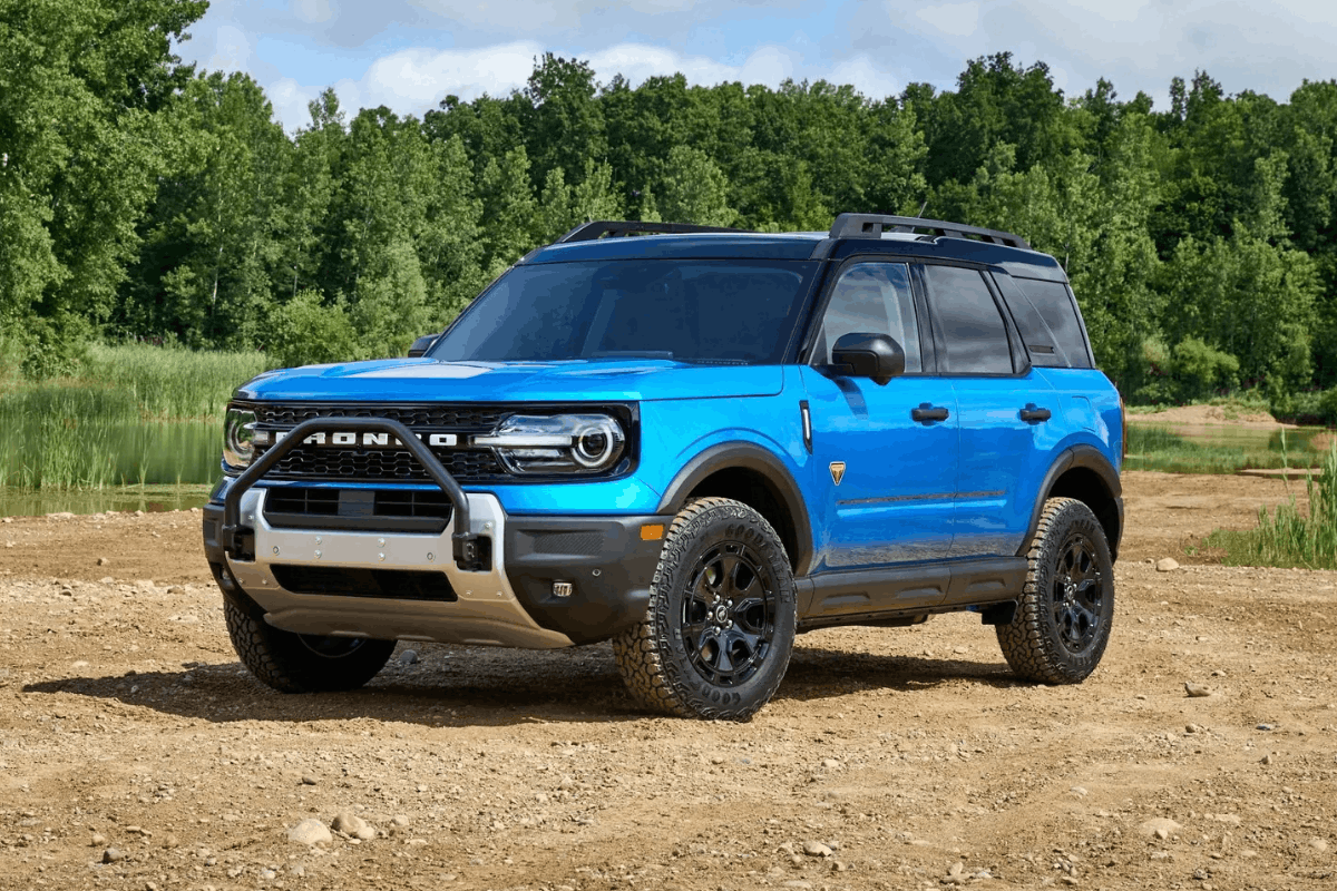 Blue 2026 Ford Bronco Sport on a wooded road