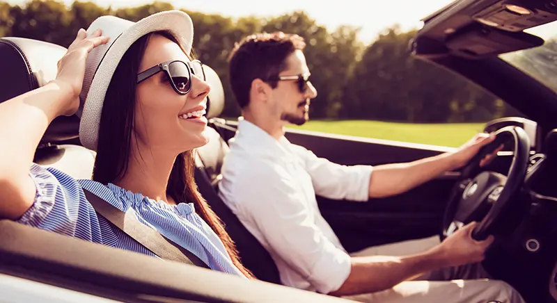 Couple driving in a convertible