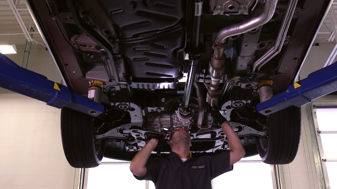 Service technician working under a lifted car