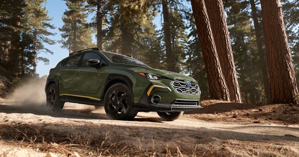 A Subaru Crosstrek driving in a forest