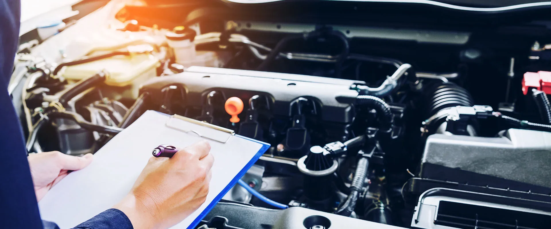 A mechanic checking under the hood