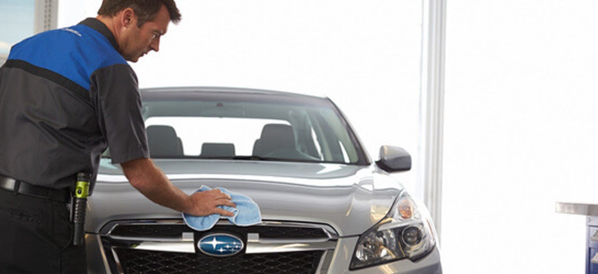 A technician wiping off a Subaru
