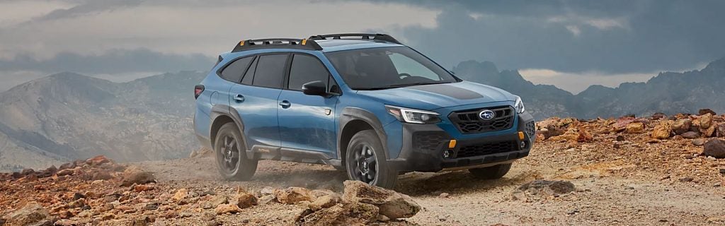 A blue Subaru in the mountains