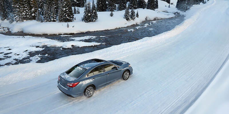 A Subaru driving in the snow