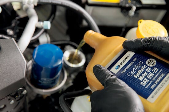 A mechanic performing an oil change