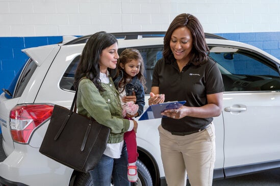 A technician explaining a report to customers