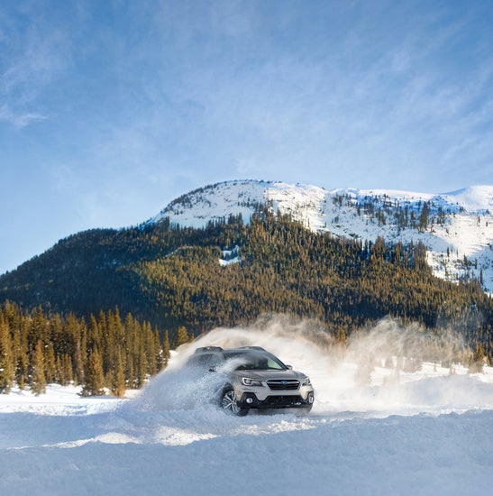 Subaru SUB driving on a heavily snowed road