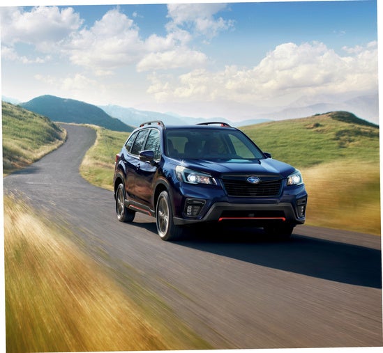 Subaru Forester driving through a rural road