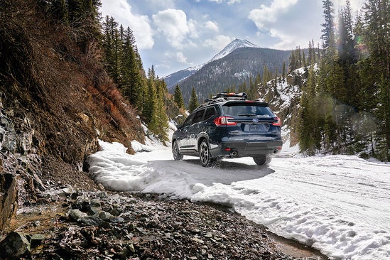 suv driving through snow