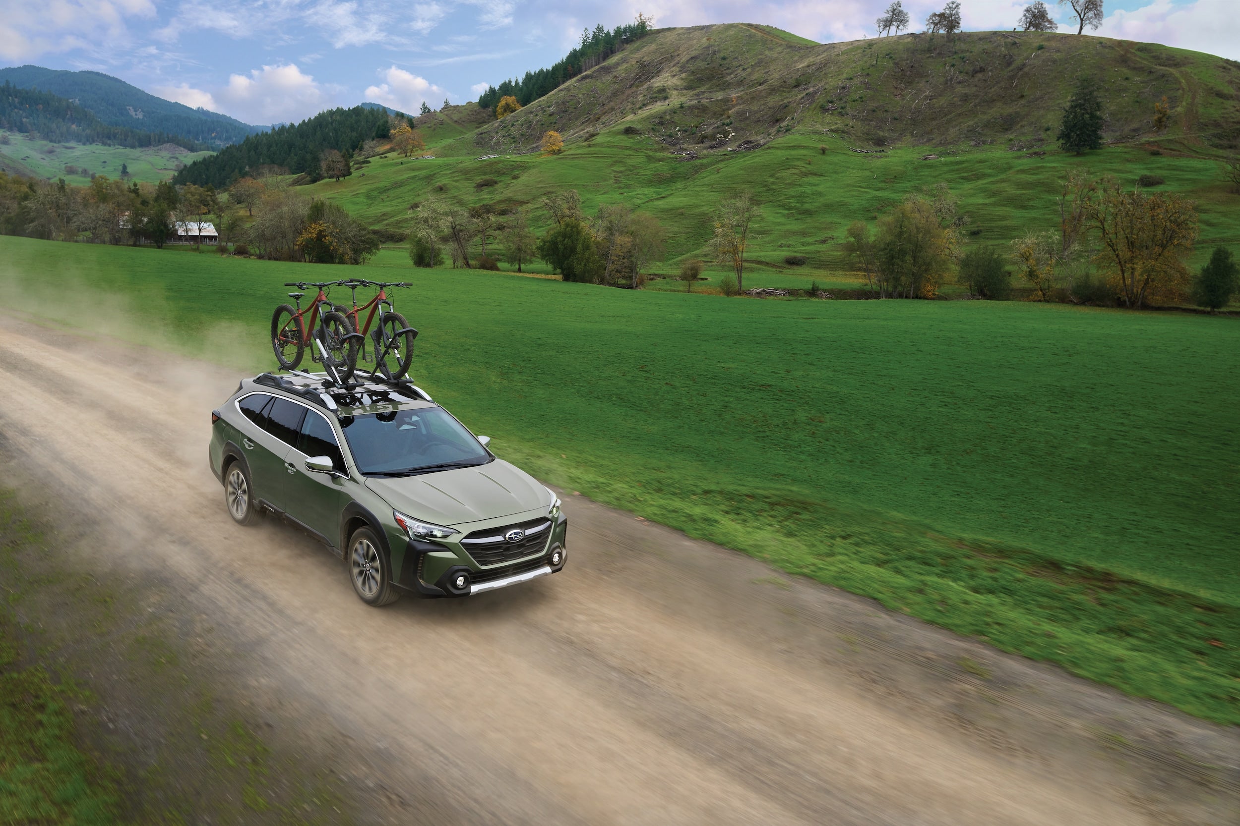 grey suv driving through the countryside