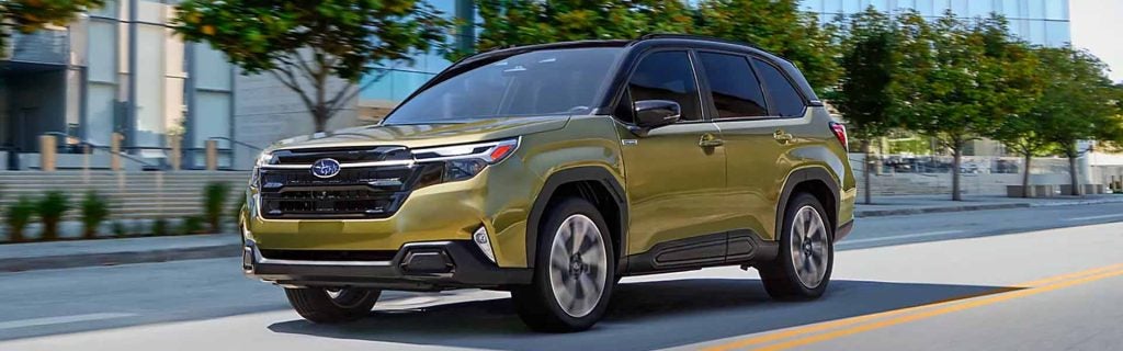 2026 Subaru Forester Hybrid driving on city street.