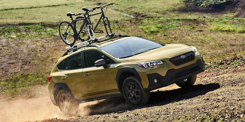 green suv driving uphill