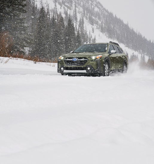 suv driving through snow