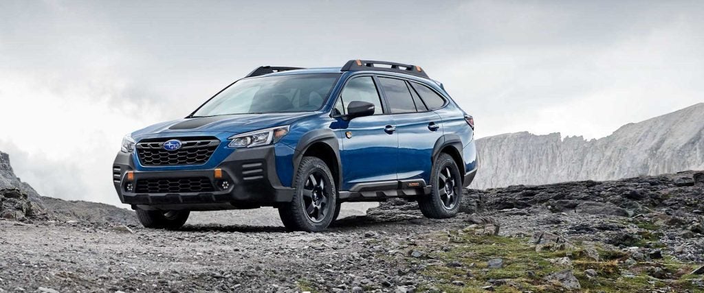 blue suv on a rocky outcropping