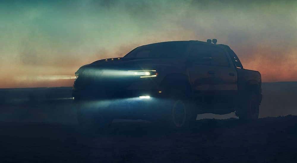 A black 2021 Ram 1500 TRX is shown parked in the fog at dusk.
