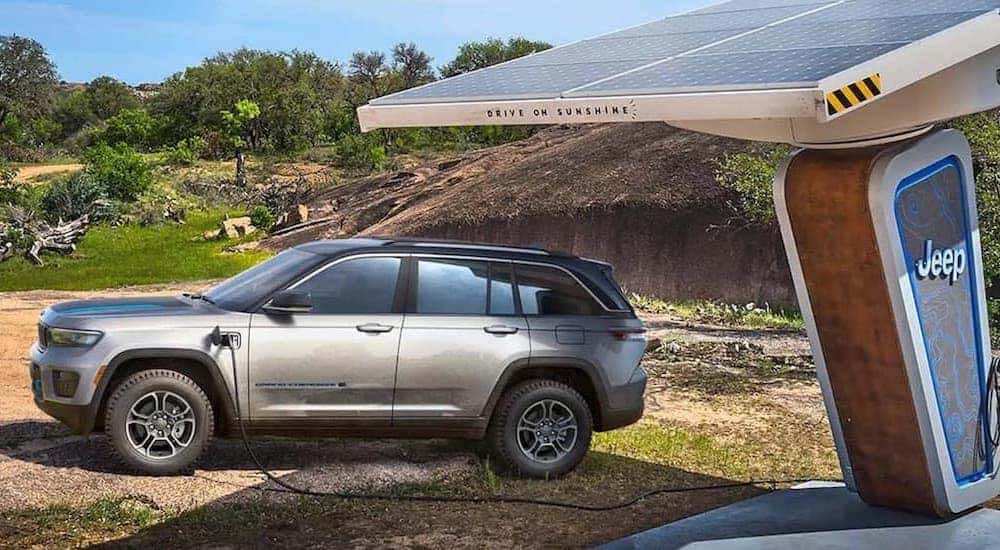 A silver 2022 Jeep Grand Cherokee 4xe is shown charging.