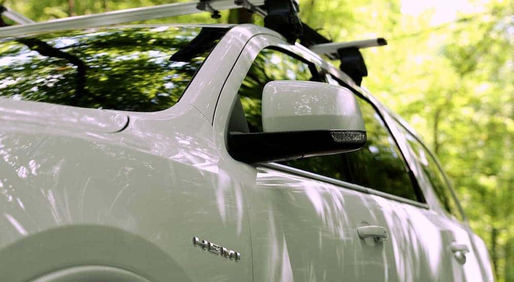 The HEMI badge is shown on the side of a white 2020 Dodge Durango from a used Dodge dealer in Lexington.
