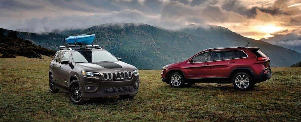 Two new 2020 Jeep Cherokee models parked on a mountain