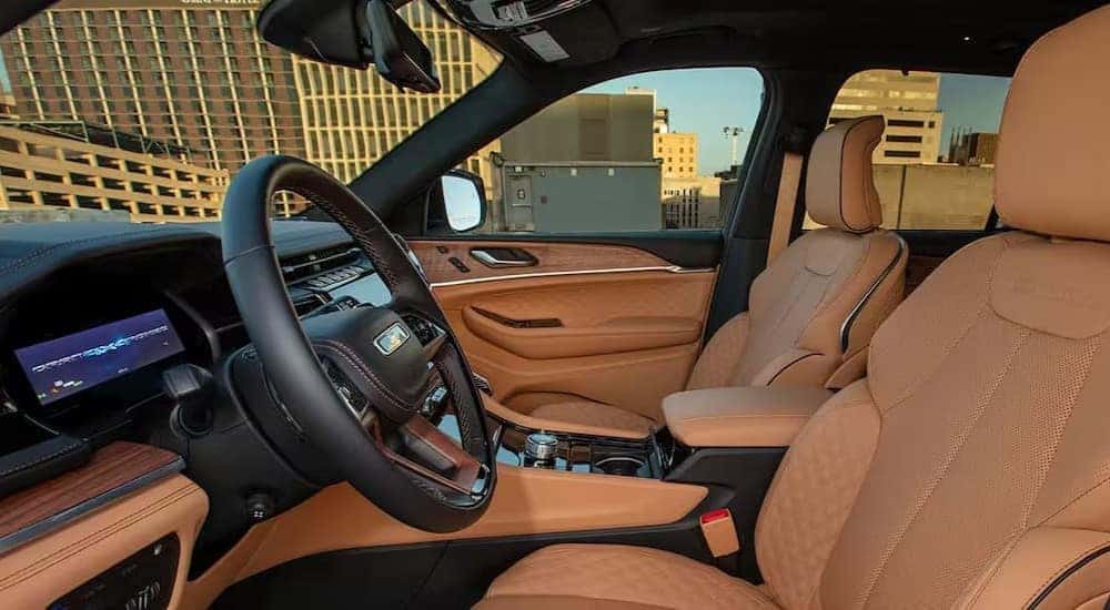 The black and brown interior and dash in a 2024 Jeep Grand Cherokee 4xe is shown.