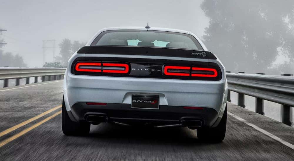 A silver 2023 Dodge Challenger SRT Hellcat is shown from the rear.
