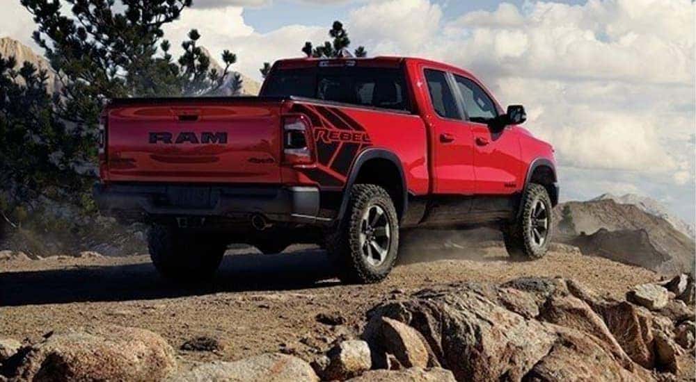 A red 2020 used Ram 1500 is shown parked in the mountains.