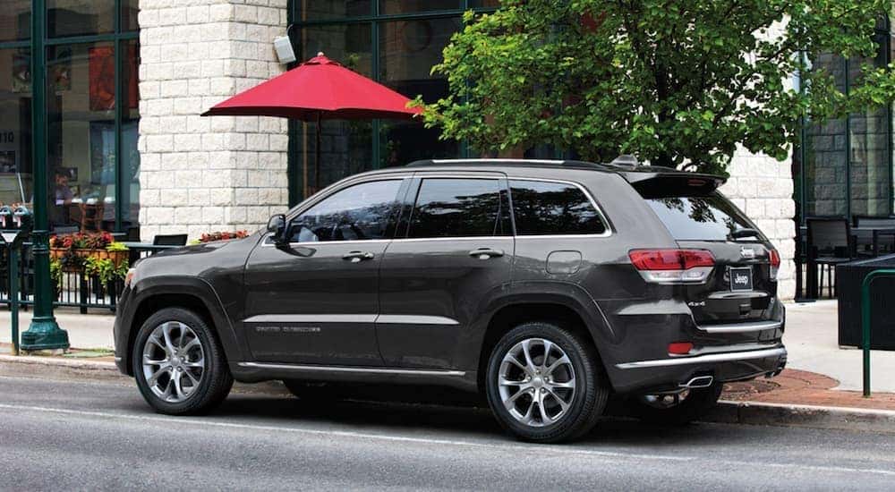 A grey 2020 Jeep Grand Cherokee Summit is shown from from the side parked in a city after searching for a used Jeep Grand Cherokee.