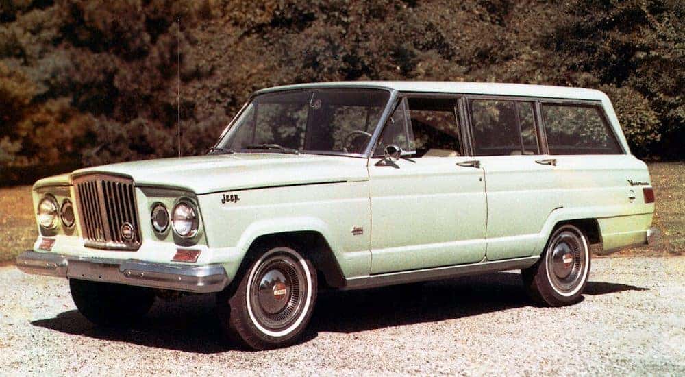 A pistachio 1962 Jeep Wagoneer is parked on the asphalt after leaving the Jeep dealer near you.